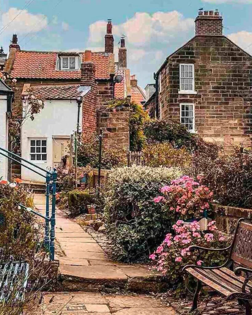 Roseworth Cottage along a flower-lined village passage