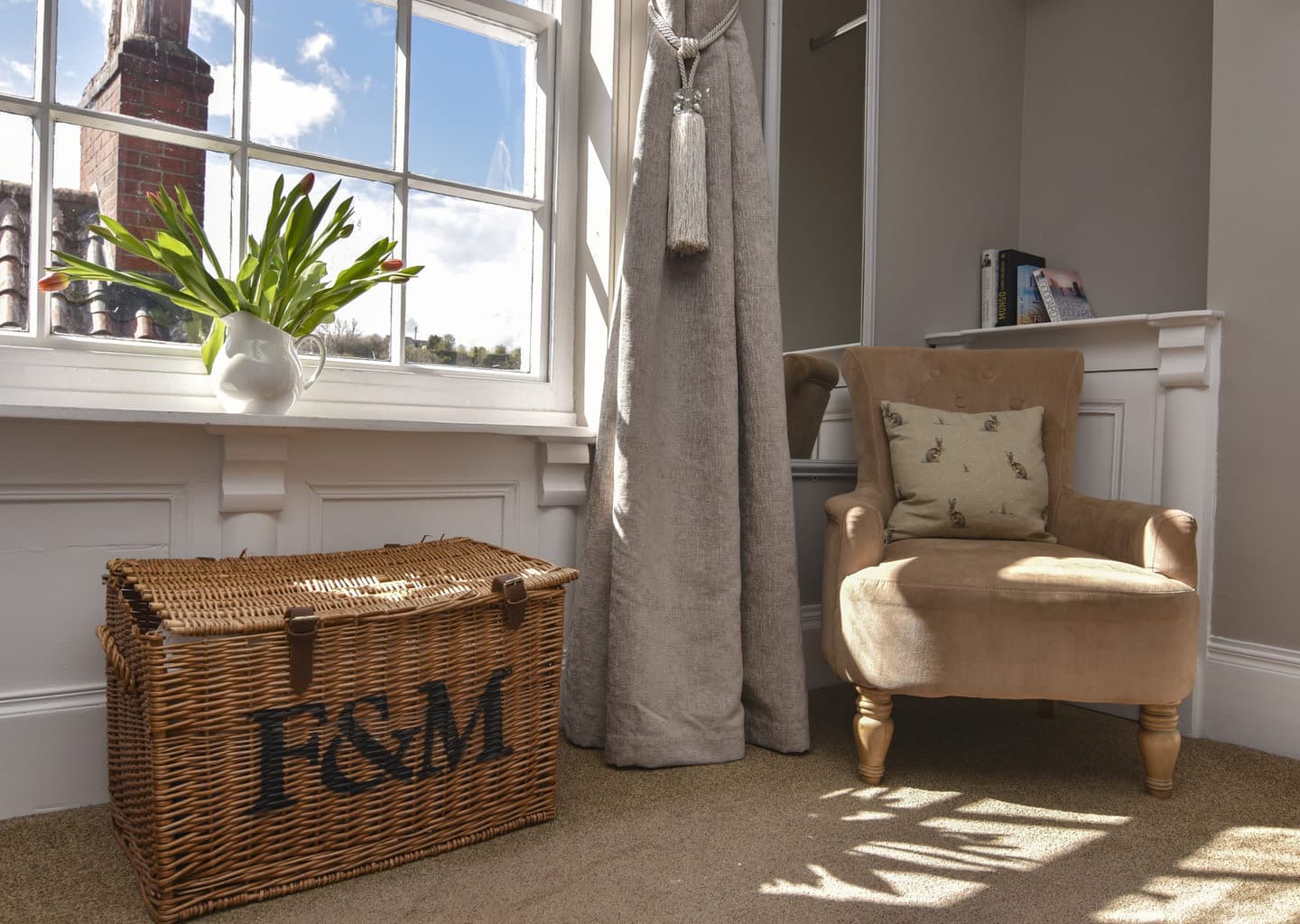 Flowers and a wicker basket beside the sash window
