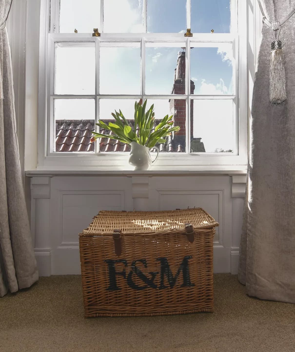 Sunlight at the window above a wicker basket