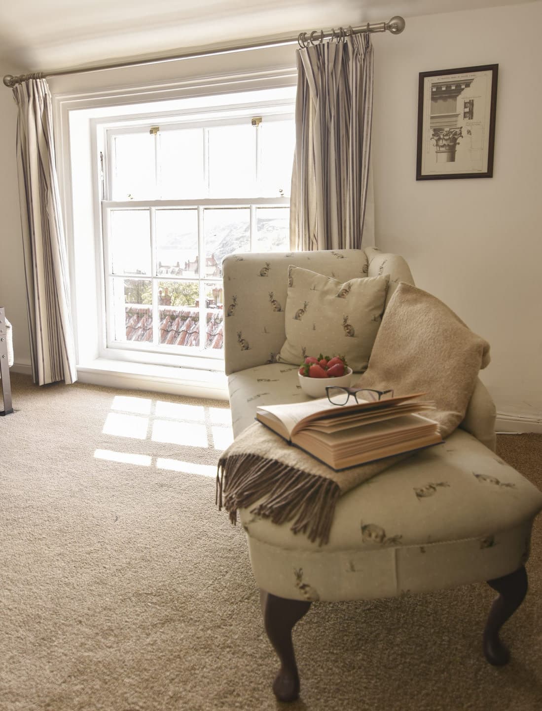 An armchair beside the bedroom window