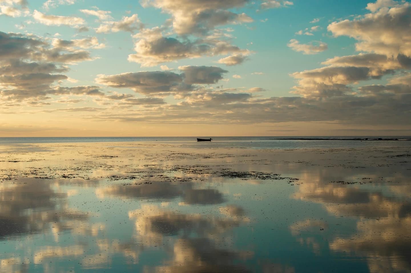Clouds reflected in the sea at sunset