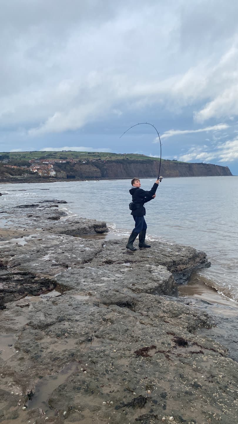A person standing beside a tide pool