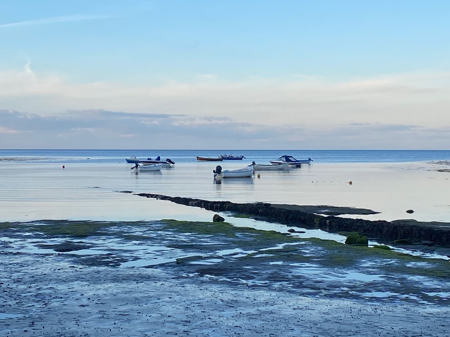 Small boats in the bay at low tide