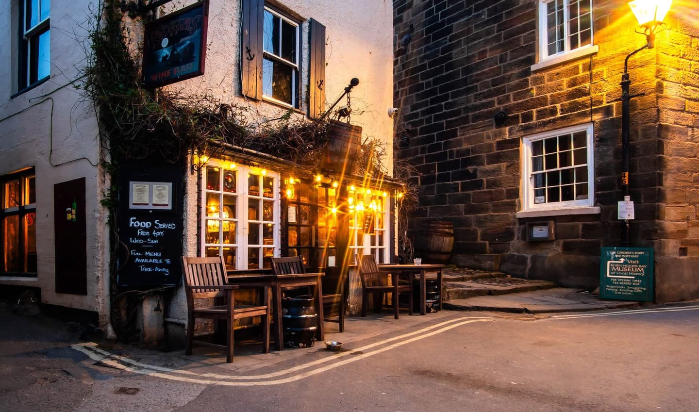 A village pub and stone passageway in evening light